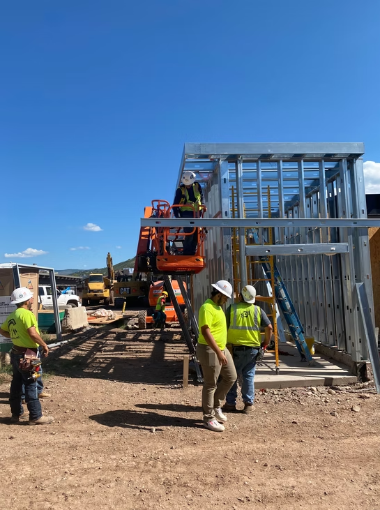 Wall To Wall crew installing metal framing at a Colorado jobsite